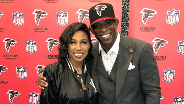 Deiondra Sanders poses with her father, Deion, at Falcons Legends event